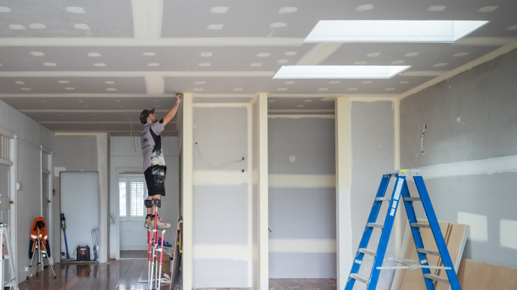 A room under construction with skylights.